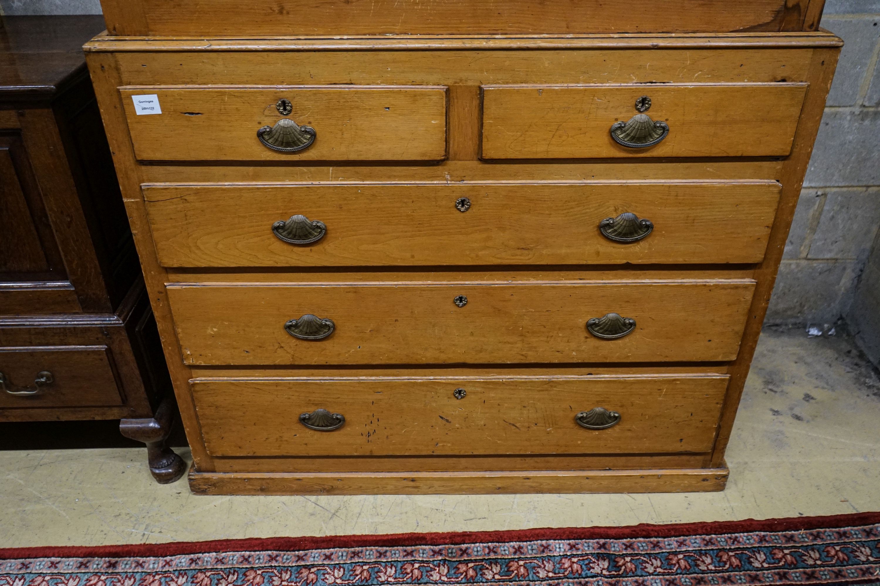 An early Victorian pine kitchen cabinet, with two panelled doors over two short and three long drawers, on plinth foot, width 118cm, depth 55cm, height 179cm